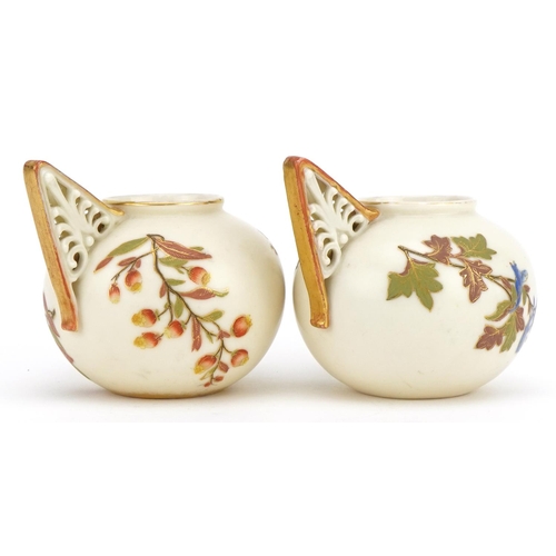 91 - Royal Worcester, pair of Victorian blush ivory vases with pierced handles, each decorated with flowe... 