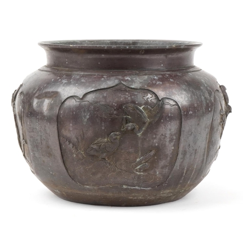 1184 - Japanese patinated bronze jardiniere decorated in relief with birds of paradise, 27cm in diameter