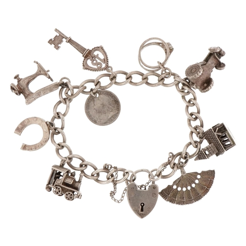 2263 - Silver charm bracelet with love heart padlock and a selection of mostly silver charms including, chu... 