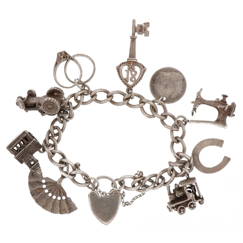 2263 - Silver charm bracelet with love heart padlock and a selection of mostly silver charms including, chu... 