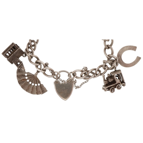 2263 - Silver charm bracelet with love heart padlock and a selection of mostly silver charms including, chu... 