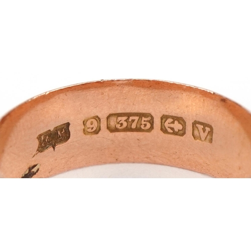 2027 - Two Victorian and later 9ct rose gold rings comprising wedding band and Gypsy ring set with a red st... 