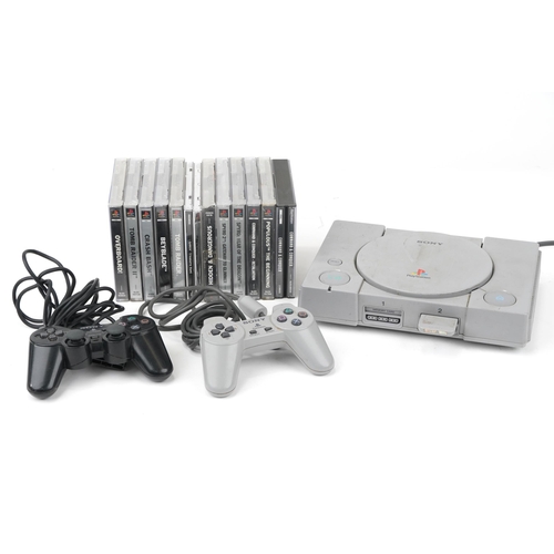 1452 - Sony PlayStation 1 games console with controllers and a collection of games