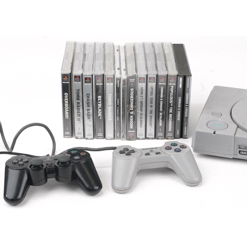 1452 - Sony PlayStation 1 games console with controllers and a collection of games