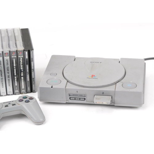 1452 - Sony PlayStation 1 games console with controllers and a collection of games