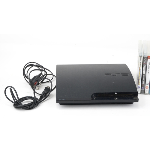 1451 - Sony PlayStation 3 games console with controller and a collection of games