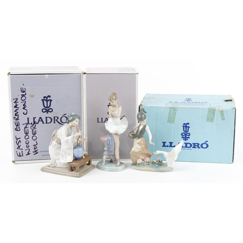 437 - Three Lladro porcelain figurines with boxes including a Geisha girl with a vase of flowers, the larg... 