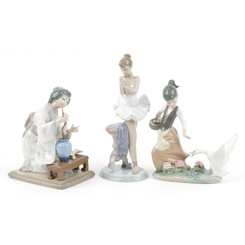 437 - Three Lladro porcelain figurines with boxes including a Geisha girl with a vase of flowers, the larg... 