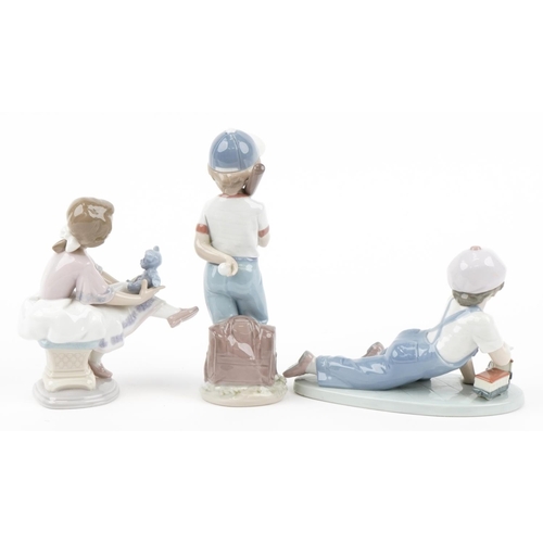 439 - Three Lladro porcelain figures with boxes comprising Boy with Train, Boy with Baseball Bat and Girl ... 