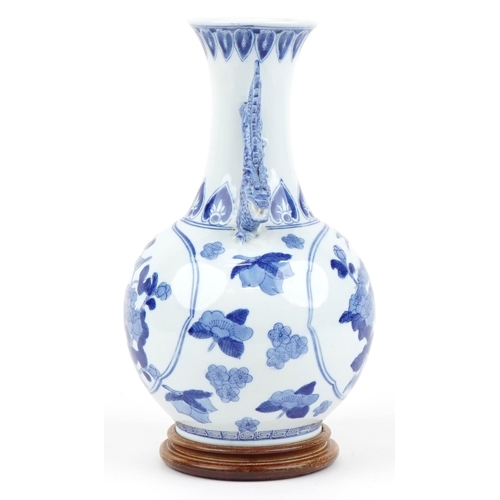 1167 - Chinese blue and white porcelain vase with dragon handles raised on a hardwood stand, decorated with... 