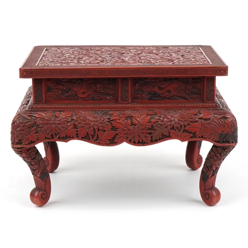 56 - Large Chinese cinnabar lacquered stand profusely carved with chrysanthemums and phoenixes, 26cm H x ... 
