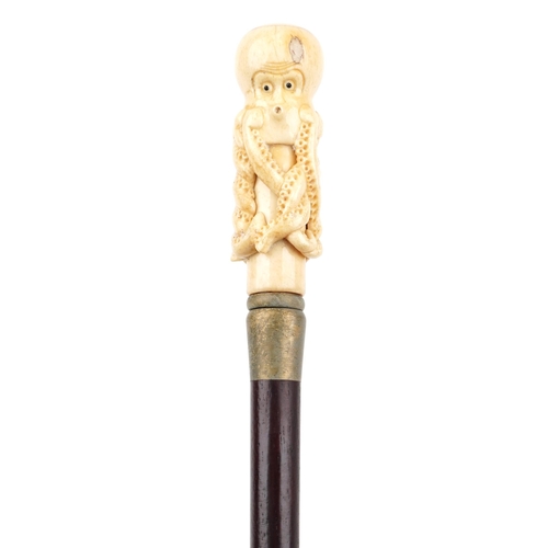 588 - Hardwood walking stick with carved bone handle in the form of an octopus, 90.5cm in length