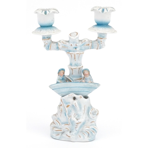 1234 - 19th century bisque two branch candelabra of two figures in a rocking boat, 21.5cm high