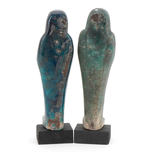 1307 - Two Egyptian style shabtis raised on painted wooden block bases, each 18.5cm high