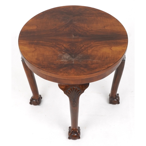 1039 - Circular walnut quarter veneered occasional table with shell carved knees and ball and claw feet, 49... 