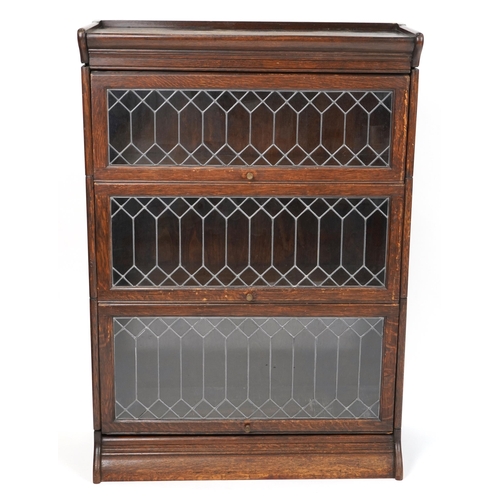 1024 - Oak Globe Wernicke style three section bookcase with leaded glass doors, 125cm H x 87cm W x 37cm D