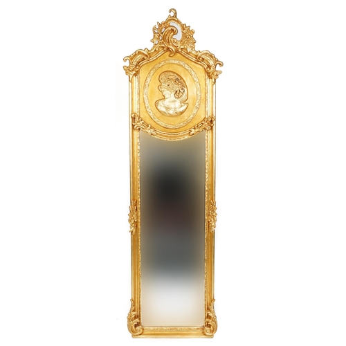 1054 - Large ornate gilt framed wall mirror with bevelled glass and relief panel of a maiden, 180cm x 53cm