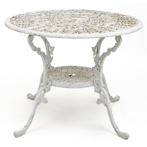 1142 - White painted aluminium garden table and four chairs, the table 67cm high x 87cm in diameter