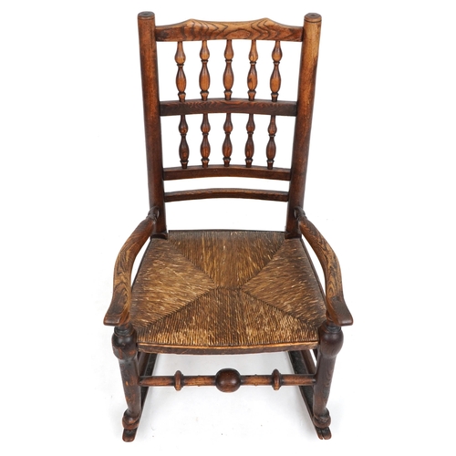 1094 - Antique elm rocking chair with cane seat, 88cm high