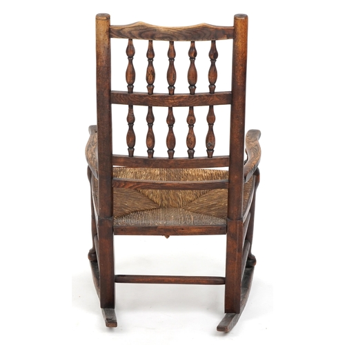 1094 - Antique elm rocking chair with cane seat, 88cm high