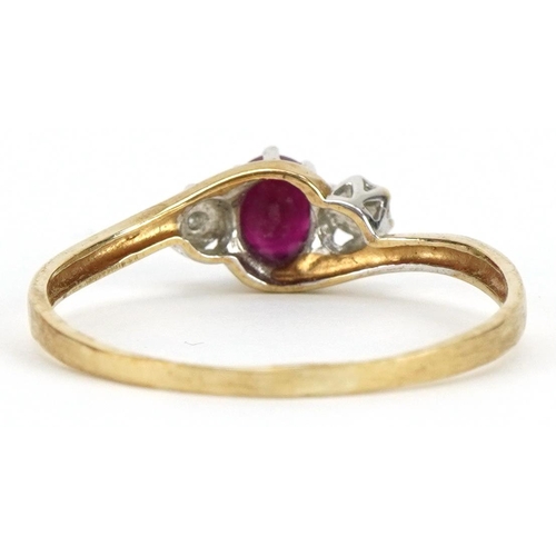 2141 - 9ct gold ruby and diamond three stone crossover ring, the ruby approximately 4.7mm x 3.8mm, size T/U... 