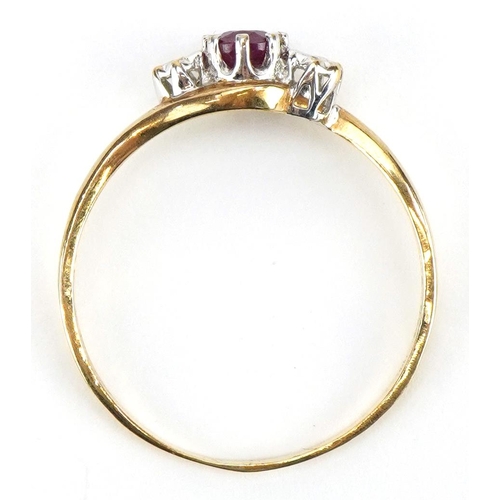 2141 - 9ct gold ruby and diamond three stone crossover ring, the ruby approximately 4.7mm x 3.8mm, size T/U... 