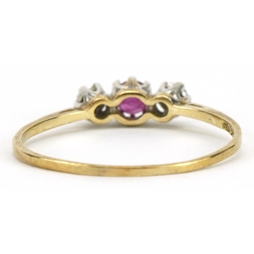 2103 - 9ct gold ruby and diamond three stone ring, the ruby approximately 3.2mm in diameter, size Q/R, 1.1g