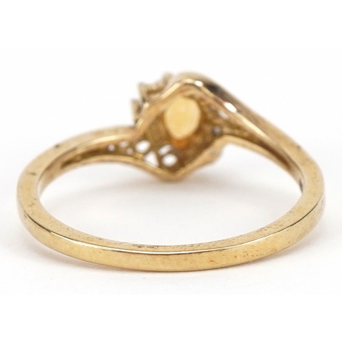 2337 - 9ct gold citrine and diamond crossover ring with pierced shoulders, size L, 1.5g