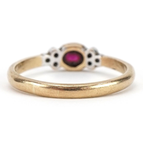 2331 - 9ct gold ruby and diamond seven stone ring, the ruby approximately 4.6mm x 3.5mm, size P, 1.9g