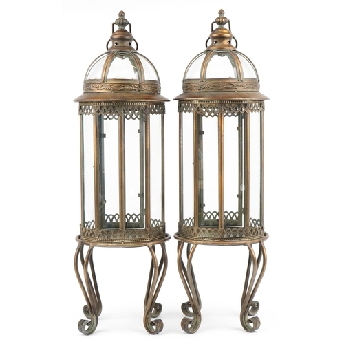 1375 - Pair of partially gilt and glazed lantern design candle holders, 82cm high