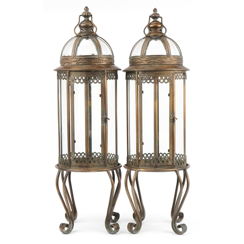 1375 - Pair of partially gilt and glazed lantern design candle holders, 82cm high