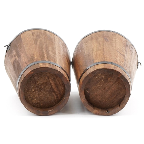 1173 - Pair of wooden barrel design Champagne ice buckets with Bollinger mottos, 40cm high