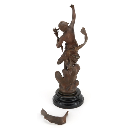 1169 - Patinated spelter study of a nude male holding a flaming torch raised on a circular ebonised base wi... 