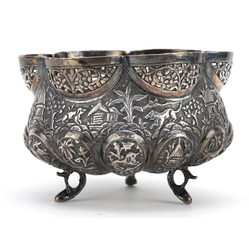 375 - Anglo Indian unmarked silver three footed bowl embossed with wild animals and huts, 10cm in diameter... 