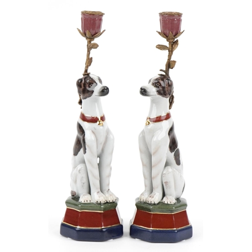 500 - Pair of continental porcelain and bronze candlesticks in the form of seated dogs, each 34cm high