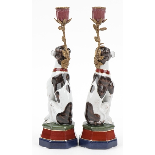 500 - Pair of continental porcelain and bronze candlesticks in the form of seated dogs, each 34cm high