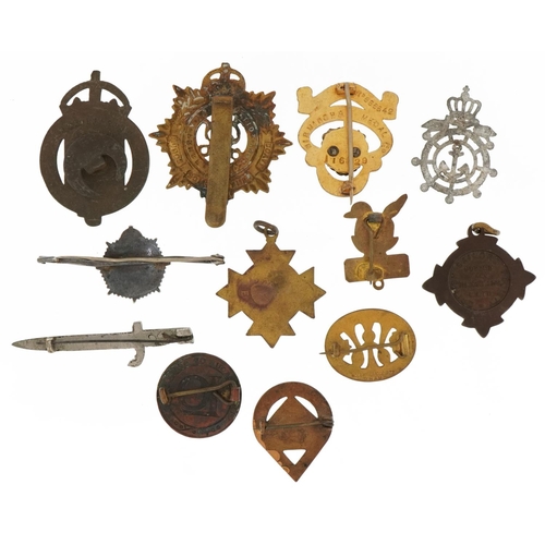 1522 - Predominantly Military and naval interest badges, brooches and cap badges including one in the form ... 