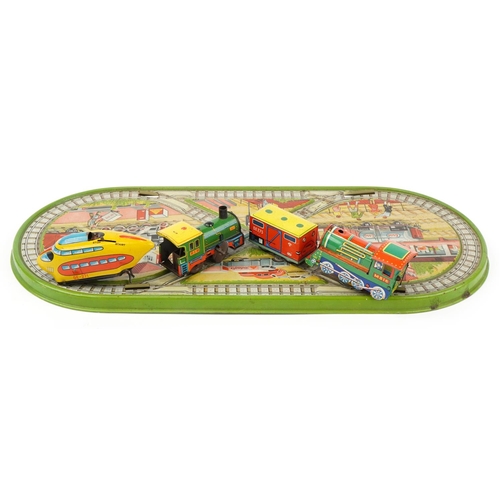 1439 - Vintage West German tinplate clockwork trainset and a US Zone German tinplate monorail train numbere... 