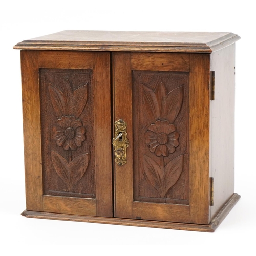 506 - Art Nouveau oak smoker's cabinet with lift up top enclosing three drawers