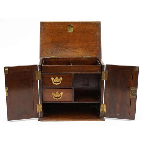 506 - Art Nouveau oak smoker's cabinet with lift up top enclosing three drawers