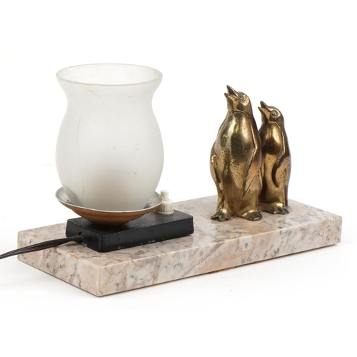 355 - Art Deco marble lamp with glass shade surmounted with two bronzed penguins, 22cm wide