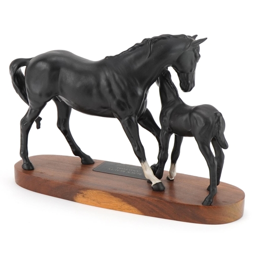 446 - Beswick Connoisseur model of Black Beauty and foal raised on a wooden plinth base, 29.5cm in length