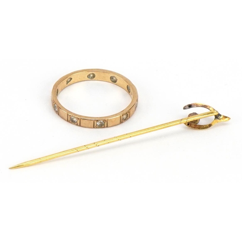 2314 - 9ct gold clear stone eternity ring and an unmarked gold wishbone stickpin set with a red stone, test... 