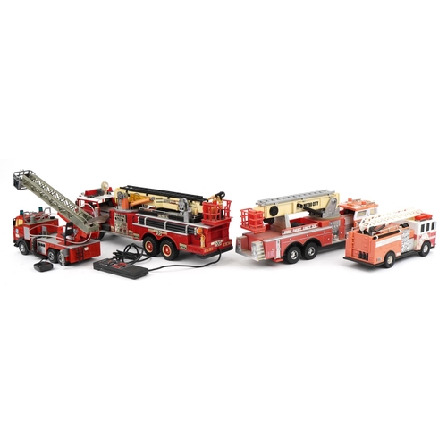 1468 - Four large vintage and later battery operated fire trucks, the largest 68cm in length