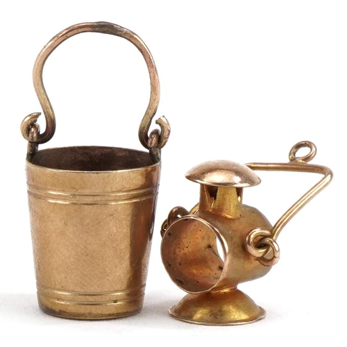 2215 - Two 9ct gold charms comprising lantern and bucket, the largest 2.3cm high, total 2.4g