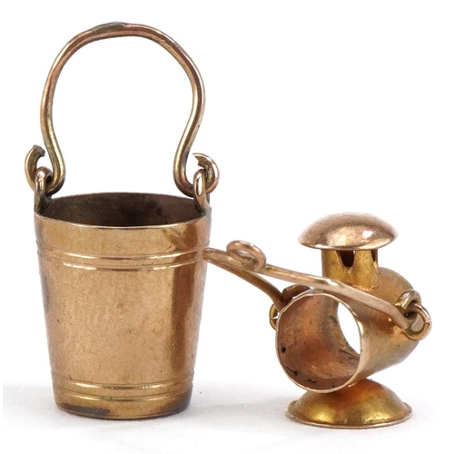 2215 - Two 9ct gold charms comprising lantern and bucket, the largest 2.3cm high, total 2.4g