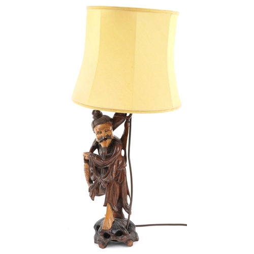 510A - Chinese root wood table lamp with shade carved in the form of a fisherman, overall 68cm high