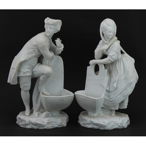 645 - Pair of bisque porcelain figural salts in the style of Chelsea, the largest 26cm high