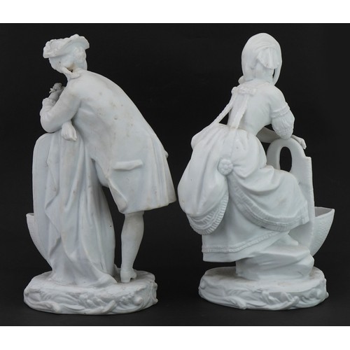645 - Pair of bisque porcelain figural salts in the style of Chelsea, the largest 26cm high