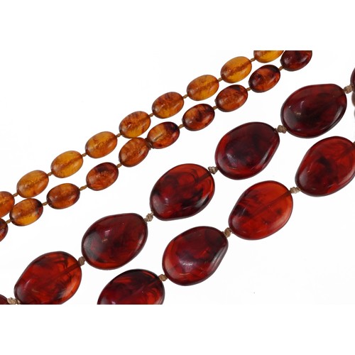 2339 - Two amber coloured bead necklaces including one with barrel clasp, the largest bead approximately 2.... 